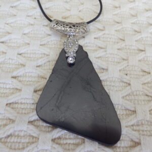 A black pendent with silver locket on it