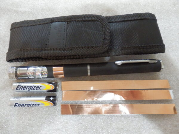 A black pen bag two batteries a EMF protection pen and 3 copper plate