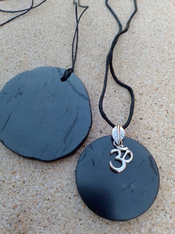 a black necklaces with a green stone pendant 2